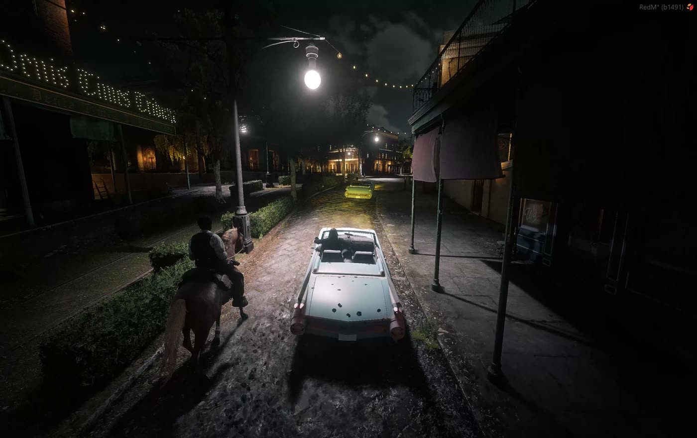 Two cars on a lit street in Saint Denis at night