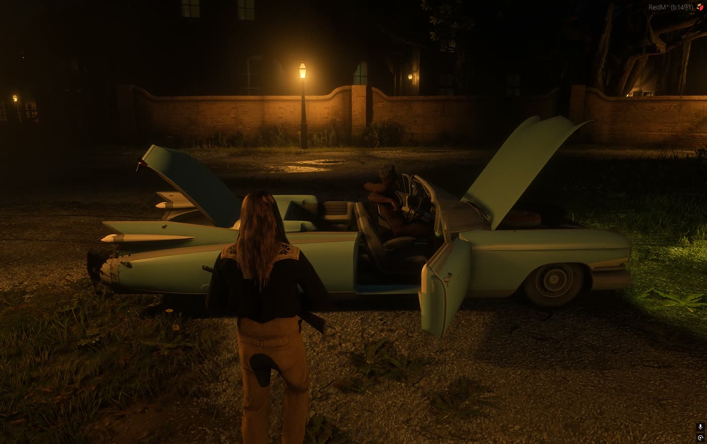 A car with hood and doors open at night