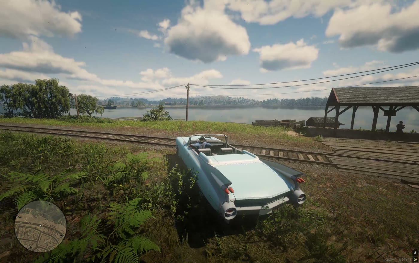A car standing on rail sleepers by the lake shore