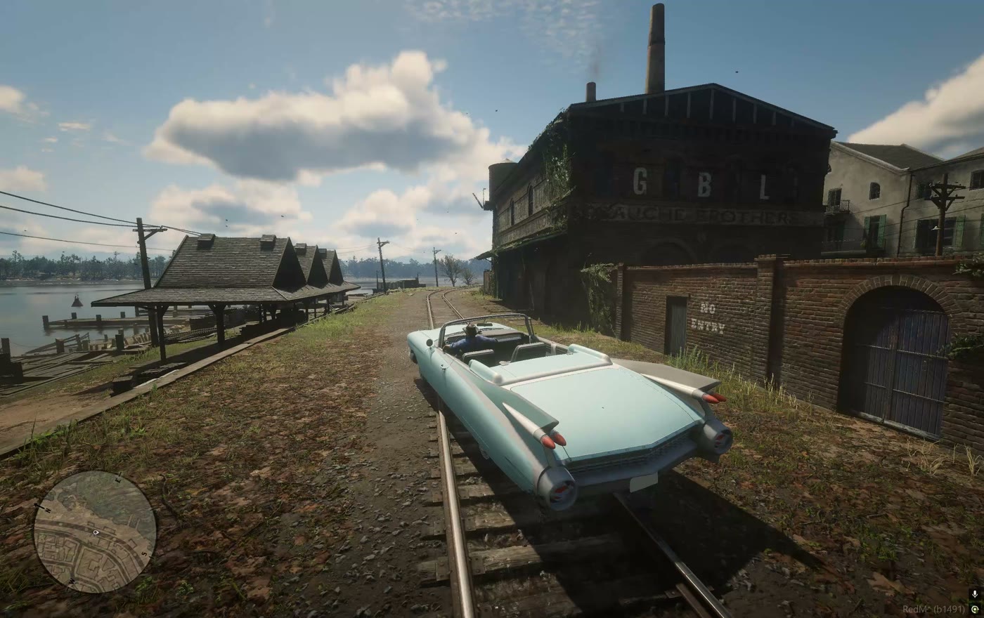 A car running along the rails toward the industrial yard