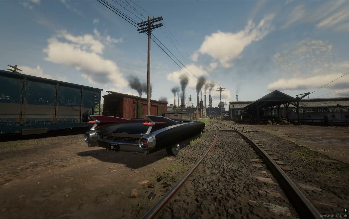 A car on the rails with the factory smokestacks behind it
