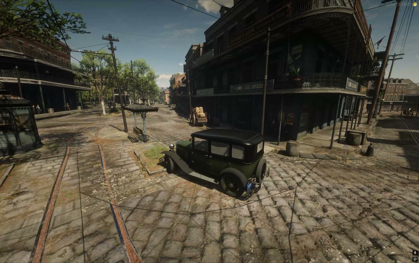 A closed body car on a cobbled street corner
