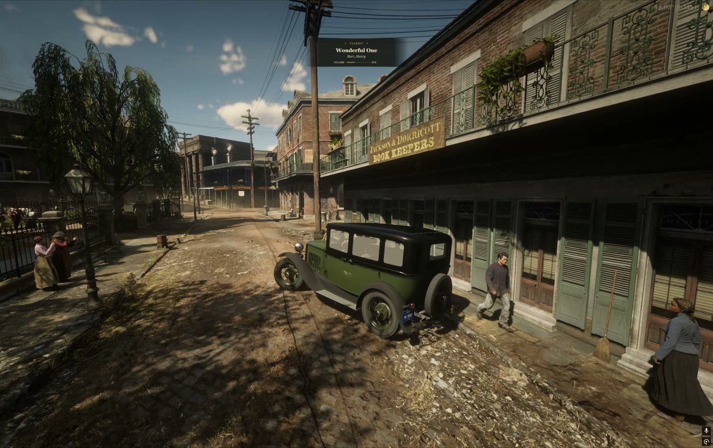 A sedan parked on a busy street with the radio playing