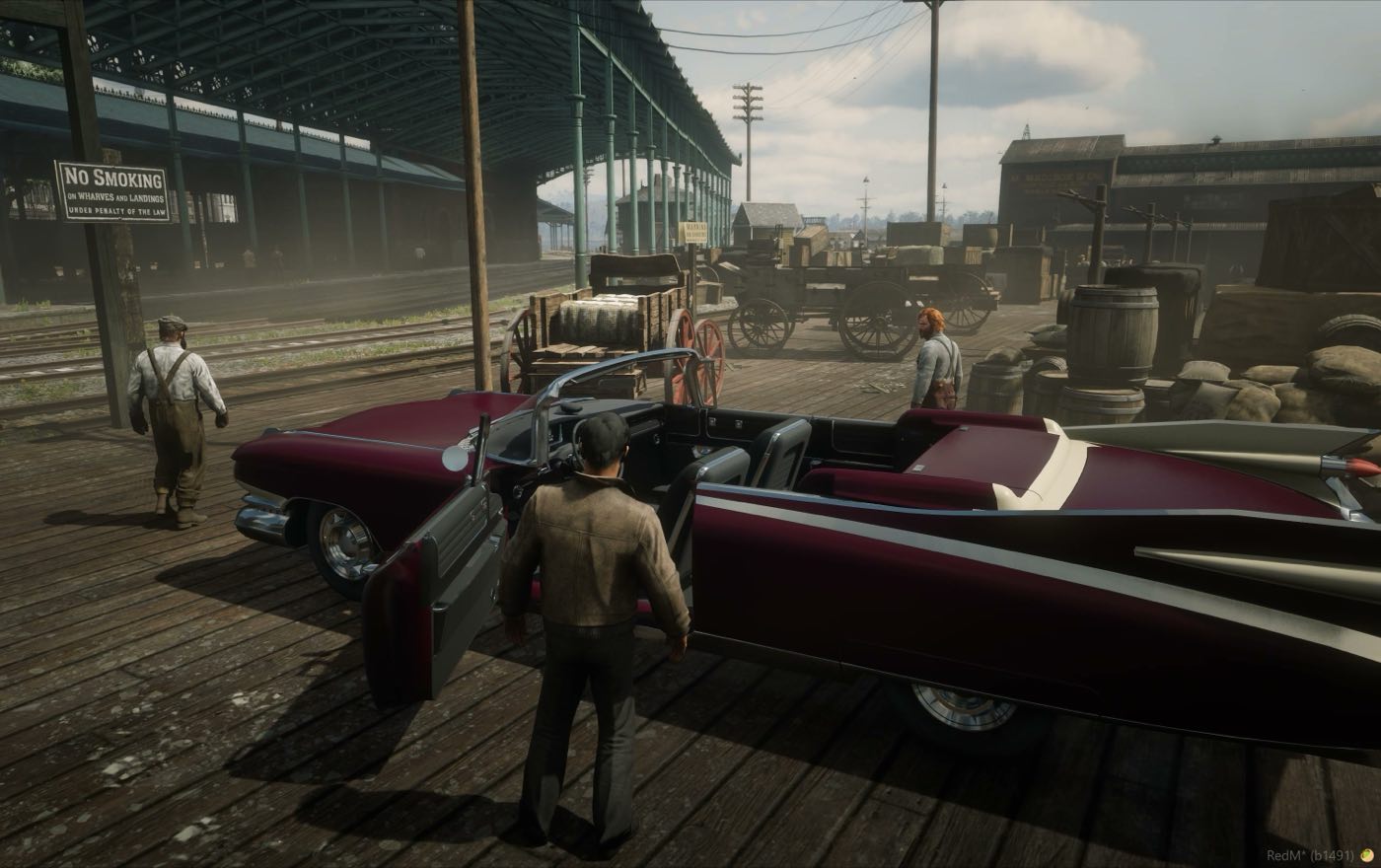 Two cars on the dock with players around them