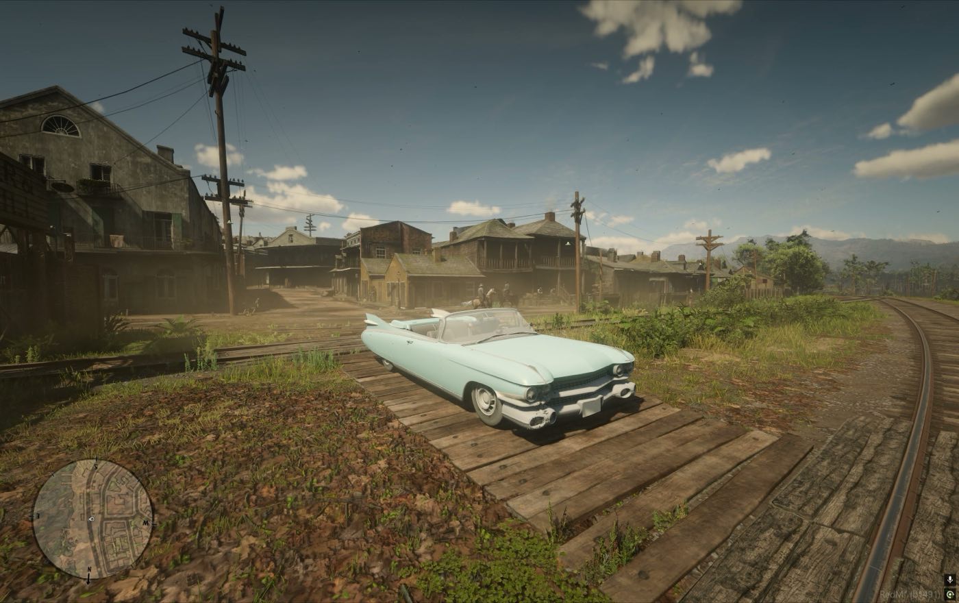 A car waiting on the sleepers with the town behind it