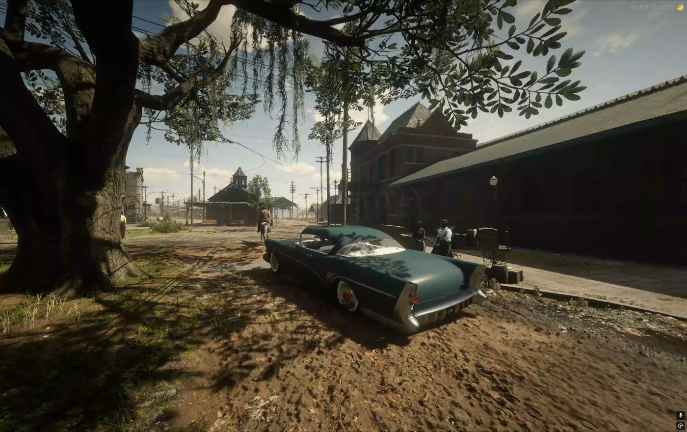A car in the shade of a live oak by the depot